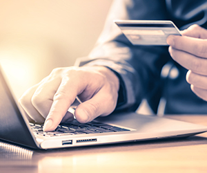 Image of a man paying for something online